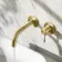 Suir Brushed Brass Wall Mounted Basin Mixer Tap with Knurled Detailing