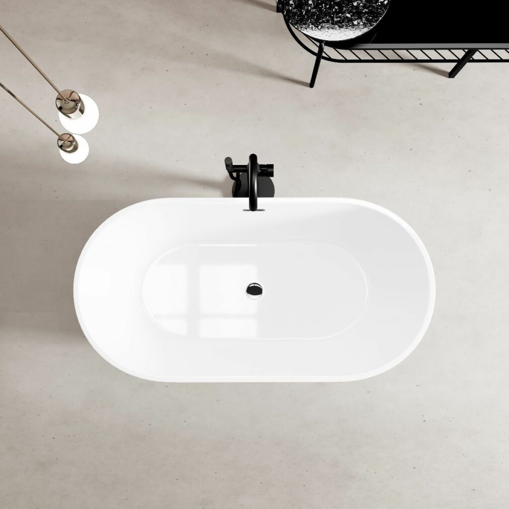 Shot of large white bath tub with black metal hardware from above.