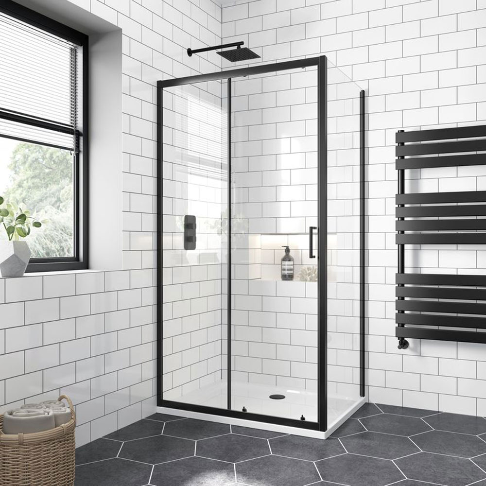 Matt black modern framed shower enclosure in black and white tiled bathroom. 
