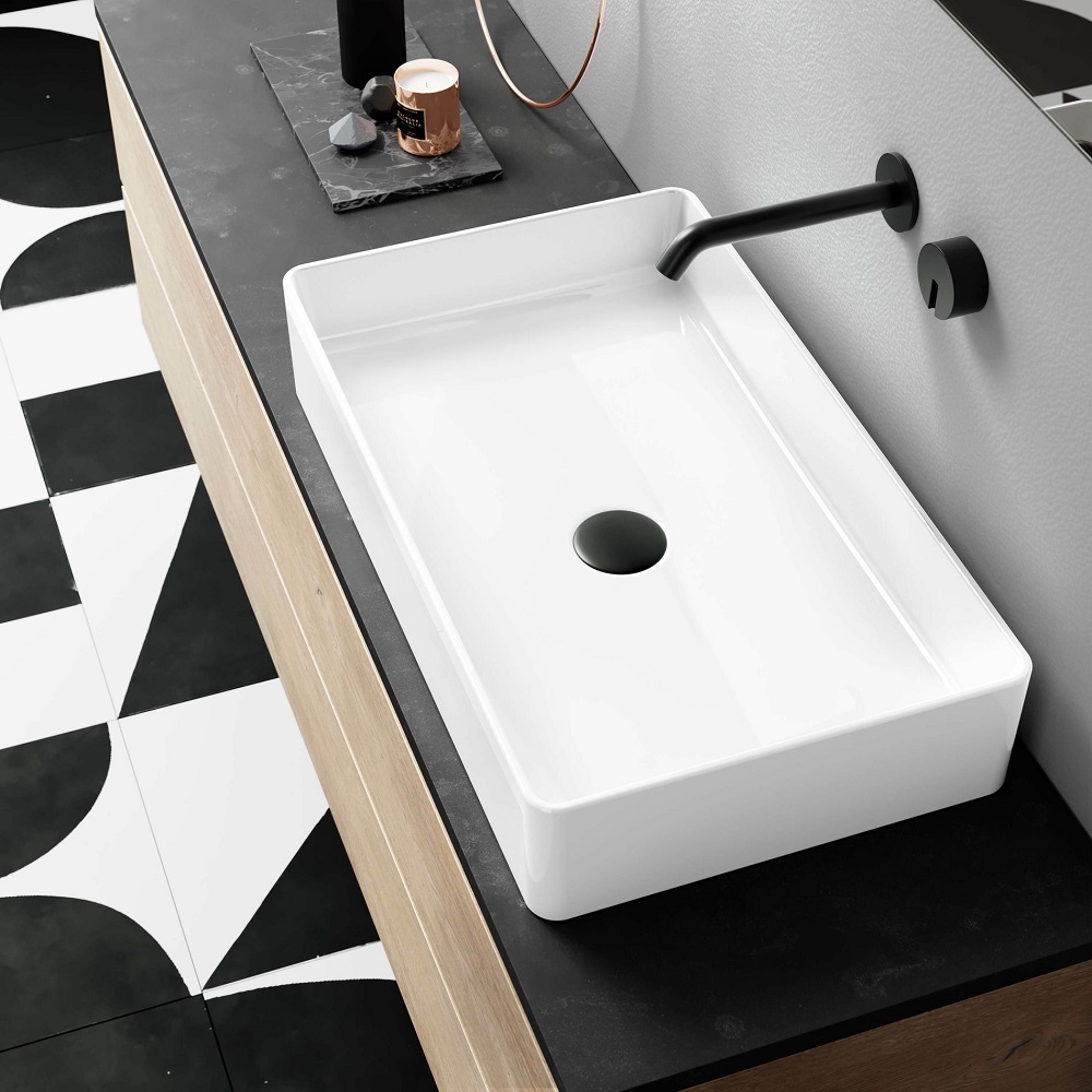 Monochrome bathroom scheme with white rectangular counter top basin and matt black wall mounted tap.