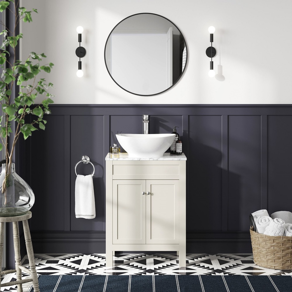Off white bathroom vanity unit with marble top and rounded counter top basin in traditional blue, black and white bathroom.