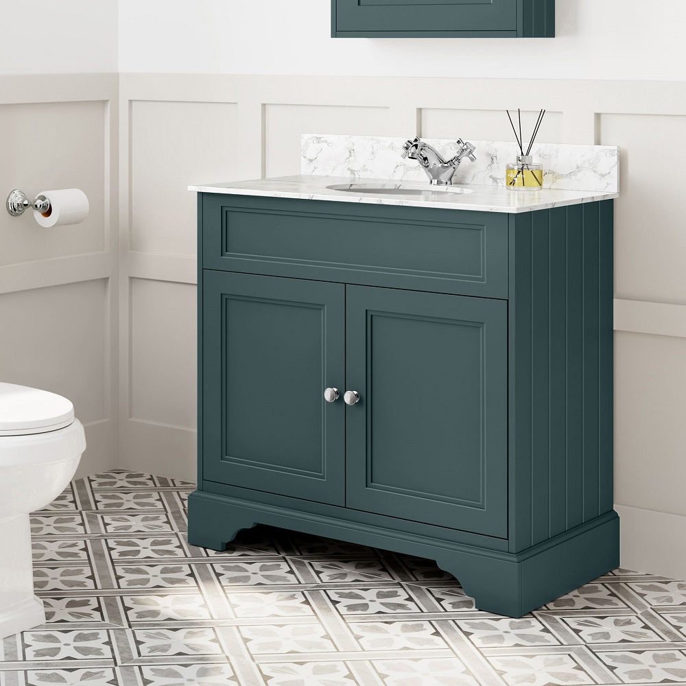 a green bathroom cabinet with marble counter top and toilet in a bathroom