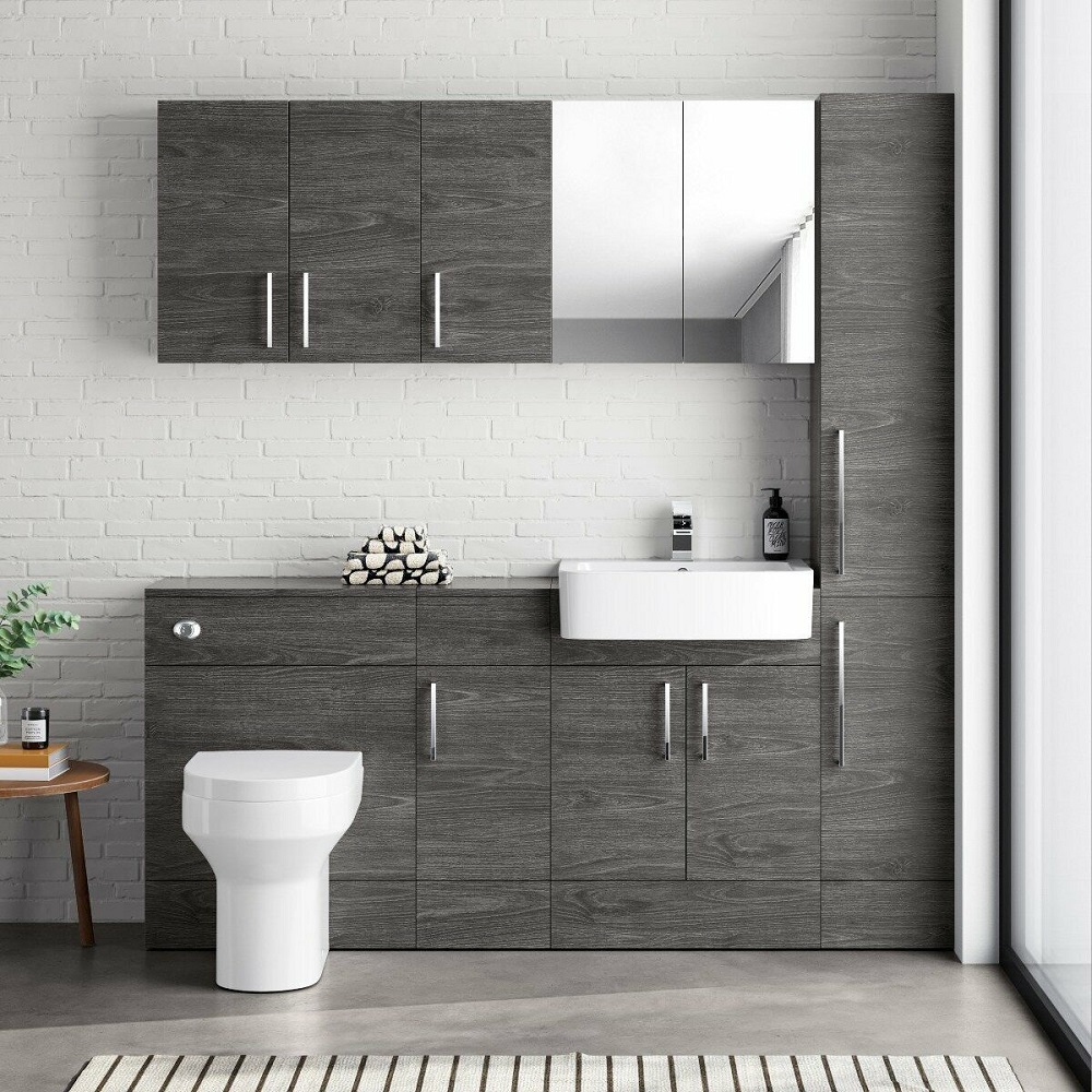 Modern bathroom with dark wood grain cabinetry, a rectangular mirror, white basin, set against a white brick wall, accented with a striped floor rug and decorative towels.
