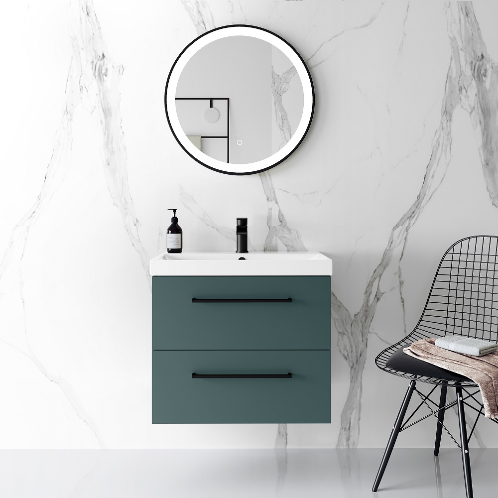 Marble bathroom with muted green wall mounted vanity basin unit and matt black hardware.
