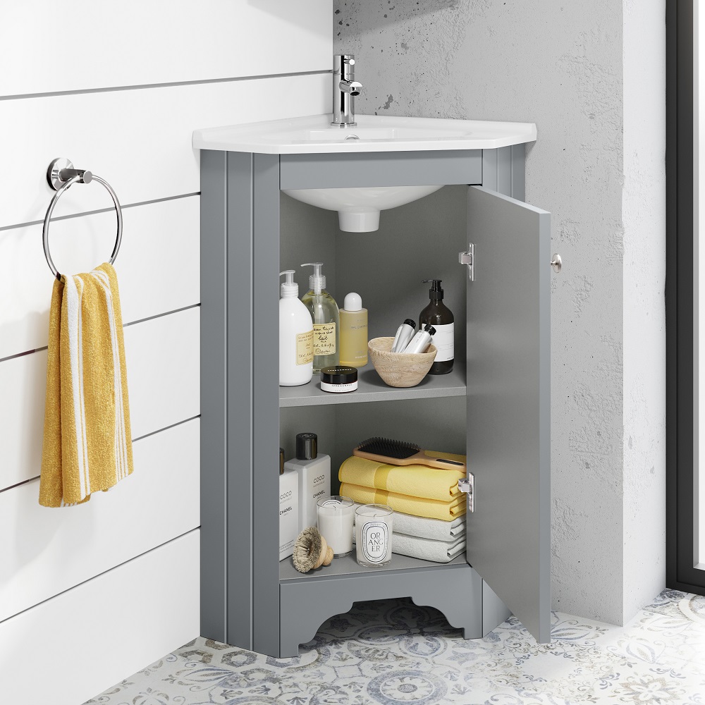 Traditional grey floor standing corner basin vanity unit with under-sink storage and yellow accessories. 