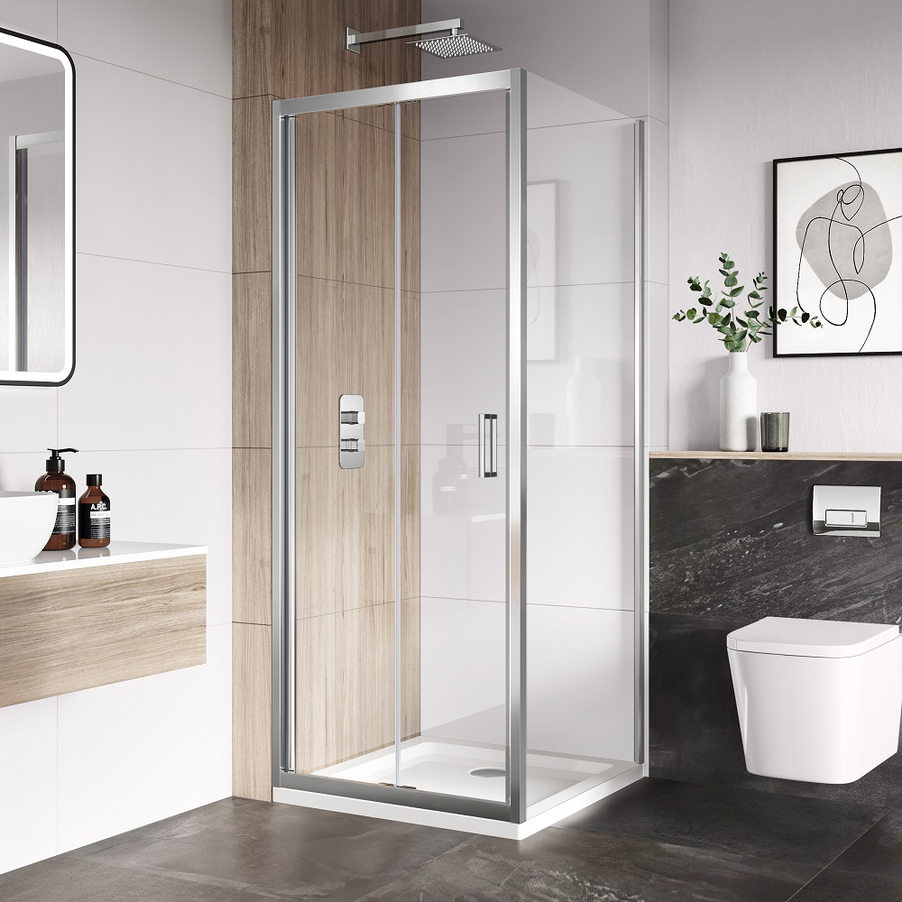 Modern bathroom with a square glass shower enclosure, wooden wall detail, and wall-hung toilet against a dark marble backdrop. A vanity with a vessel sink is on the left, and simplistic decor adds a touch of elegance. 
