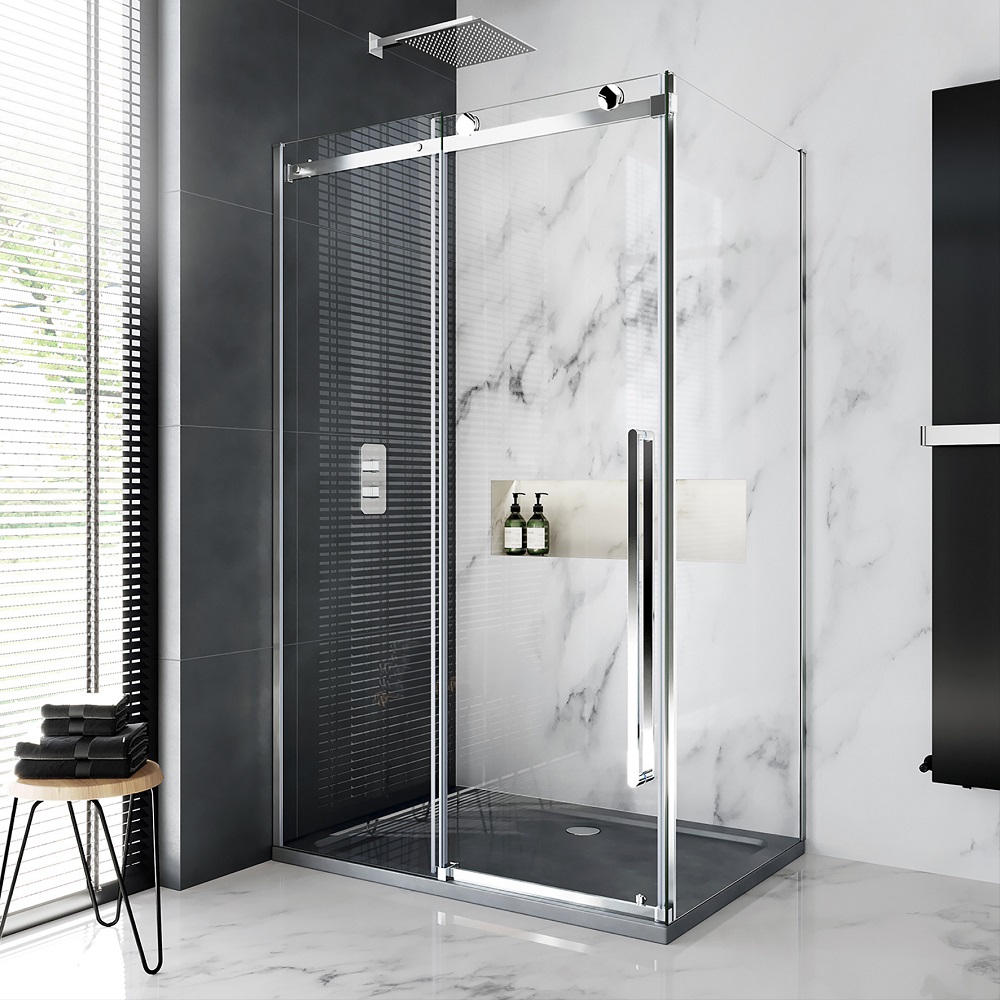 A stylish bathroom with a square shower enclosure featuring a dark tray and rain shower head. Black tiles contrast with white marble walls, and a black stool with towels is on the left. Natural light filters in through blinds. 