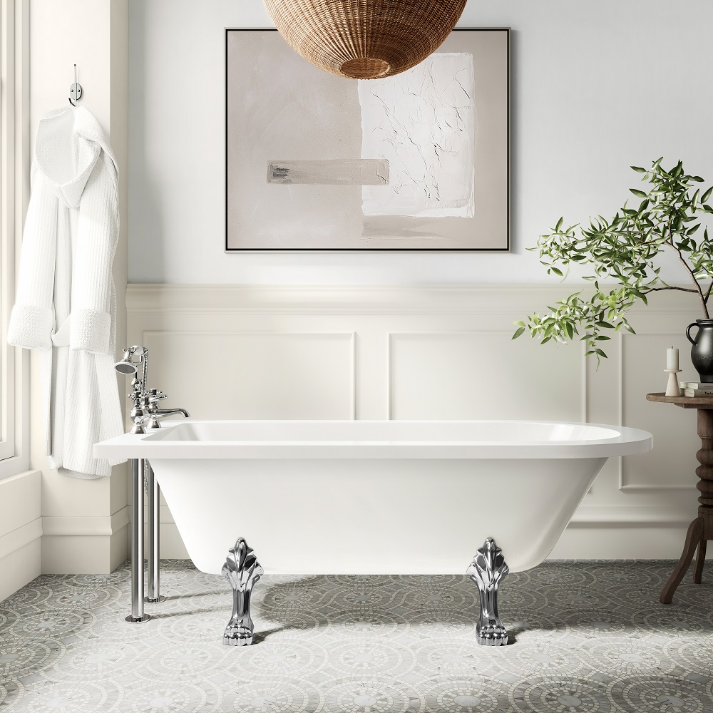 Sumptuous single-ended roll-top bathtub with chrome claw feet set against a traditional white wainscoted wall, complemented by an artistic abstract painting and a natural wicker pendant light, creating a serene spa-like bathroom atmosphere. 