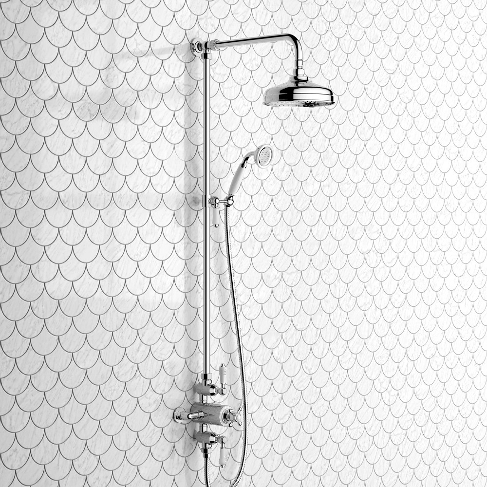 Vintage inspired thermostatic shower set on a fish scale tile patterned wall, featuring a classic round rain shower head and a handheld shower with a flexible hose, all finished in polished chrome. 